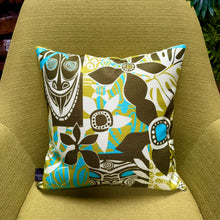 Jeff Granito's 'Oceanic Legacy' pillow cover features vibrant tropical patterns in brown, green, and blue hues.