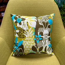 Vibrant Jeff Granito 'Oceanic Legacy' pillow cover featuring tropical patterns on a green chair backdrop.