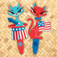 Colorful metal yard stakes featuring patriotic cats in red and blue attire, ideal for Independence Day decor.
