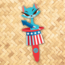 Whimsical Independence Cat yard stake featuring a blue cat with a patriotic design and rocket, perfect for decoration.