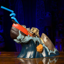 Ceramic Tiki Mug shaped like a shipwreck with a shark, featuring a blue spiral straw, perfect for cocktails.