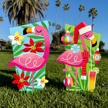 Colorful large metal yard stakes featuring flamingos with holiday decorations, perfect for festive outdoor decor.