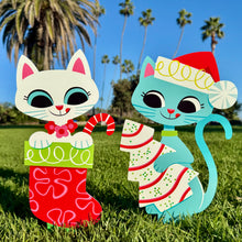 Colorful large metal yard stakes featuring festive cats in holiday attire, perfect for seasonal decor.
