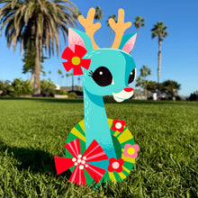 Colorful large metal yard stake of a cheerful reindeer decorated with flowers, perfect for holiday decor.