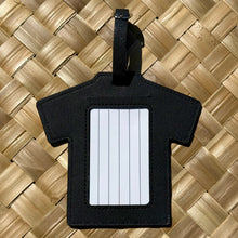 Aloha luggage tag in a shirt shape, featuring a blank card for personal details, set against a woven background.
