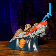 Ceramic Tiki mug depicting a shark and a sinking boat, complete with a blue straw and vibrant ocean colors.