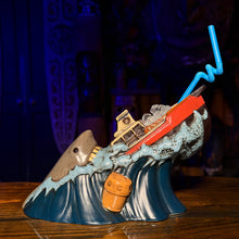 Ceramic Tiki mug shaped like a shark attacking a boat, featuring vibrant colors and a fun design for tiki lovers.