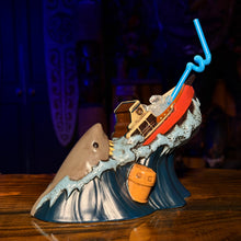 Handcrafted ceramic Tiki mug depicting a shark and sinking ship, perfect for tropical cocktails and barware collectors.